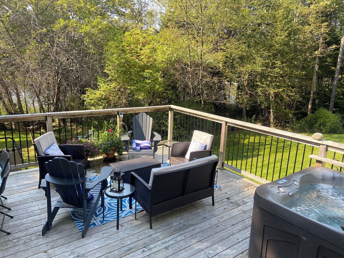 Back deck with Adirondack chairs and hot tub