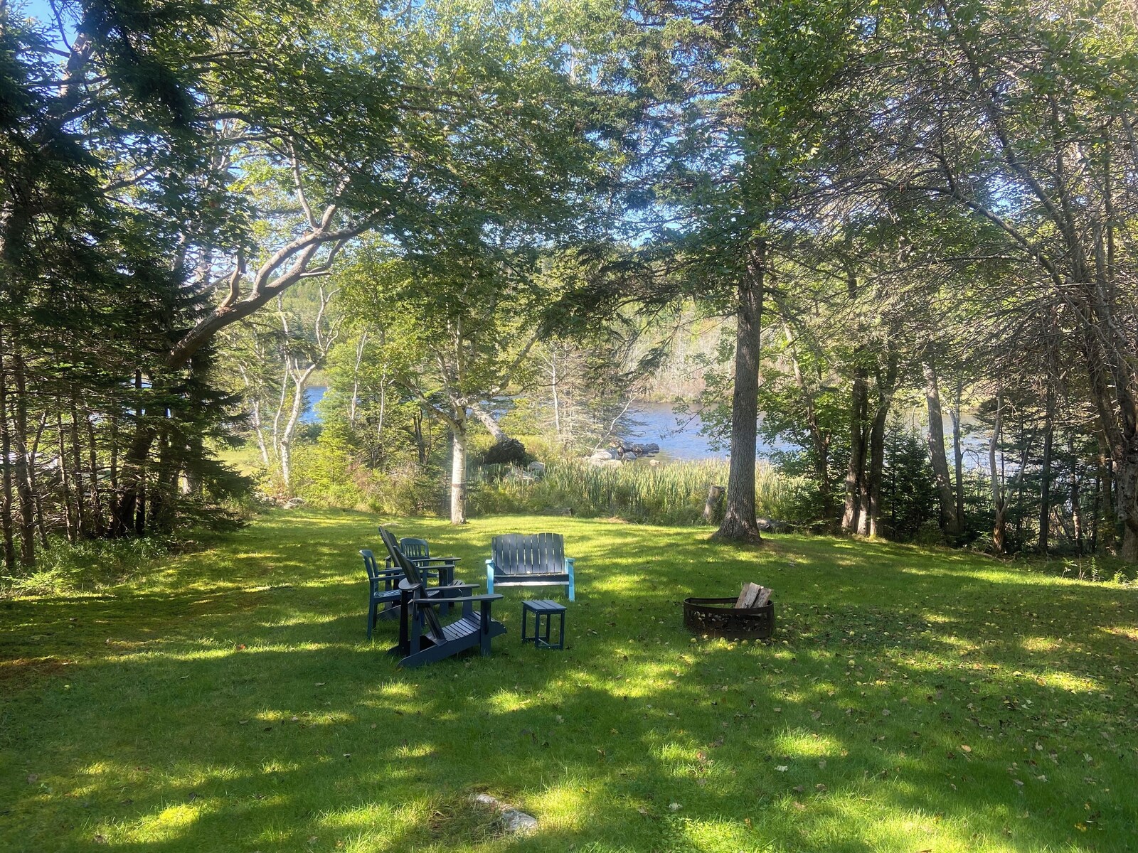 Lawn seating and fire pit beside the lake