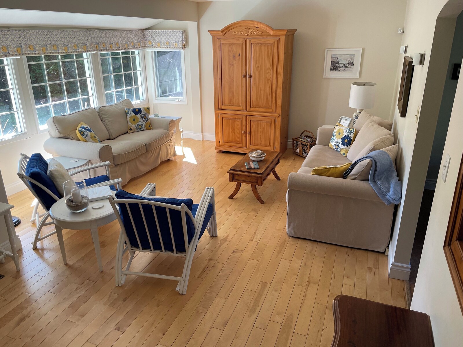 Living room with wooden armoire and sofas